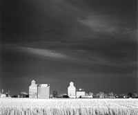 Grain elevators in stormy skies
